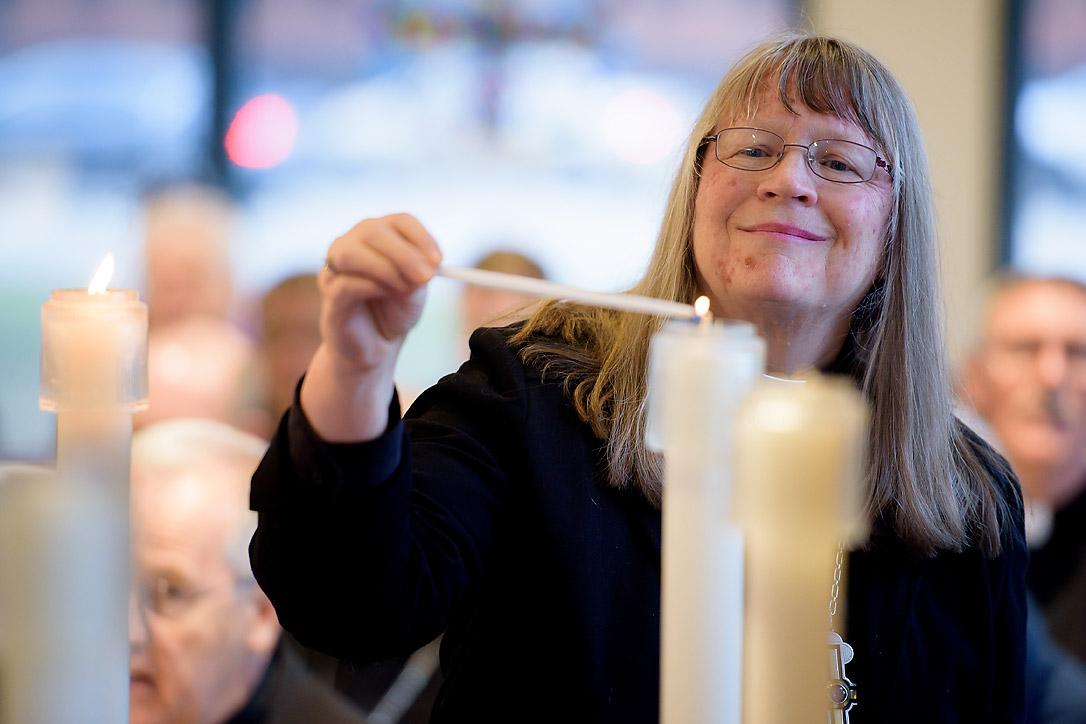 Rev. Jessica Crist, bishop of the Montana Synod of the Evangelical Lutheran Church in America, lights one of the candles for the ecumenical imperatives. Photo: C. Jason Brown/Insight Images