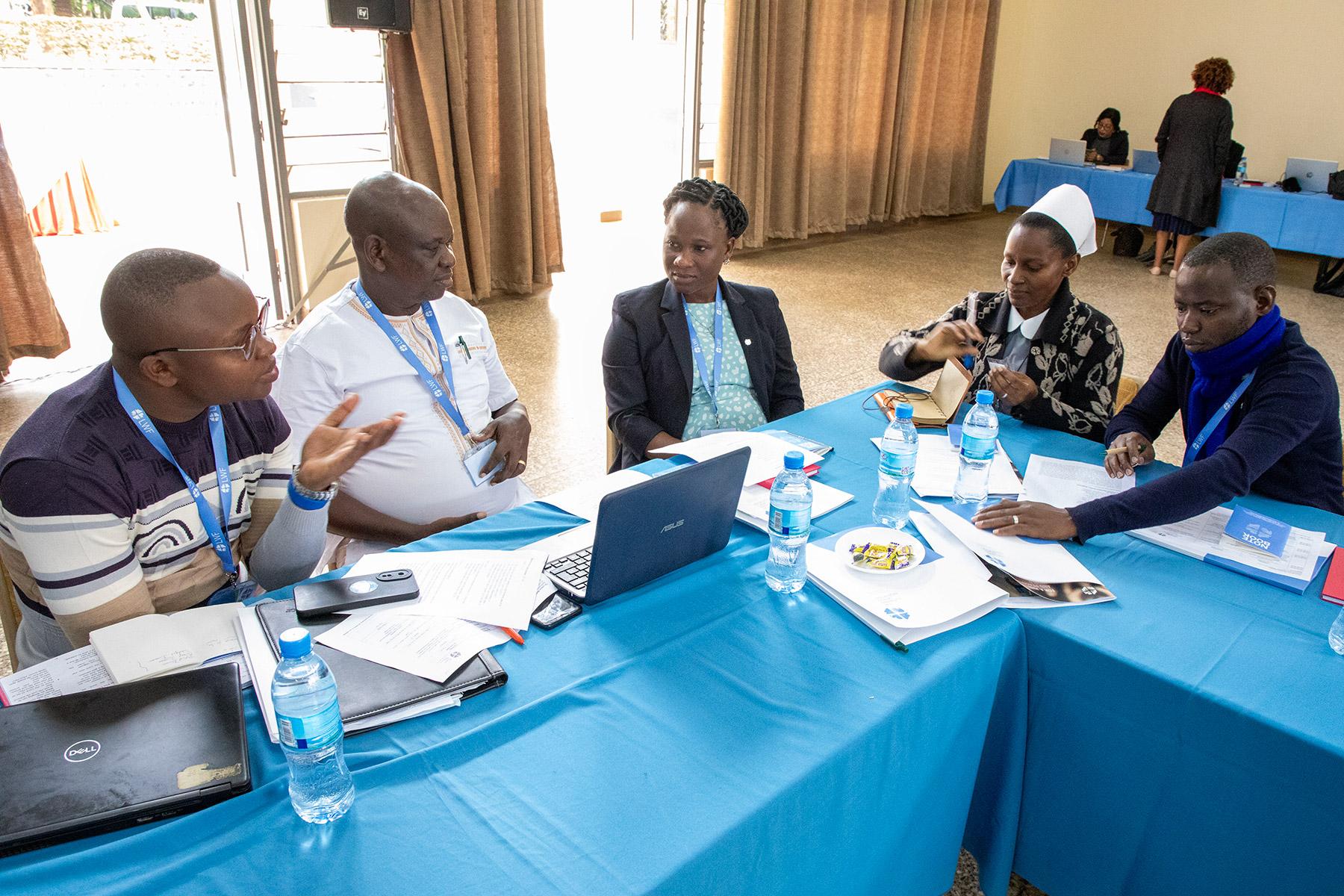 From left to right: Mr Maro Micah Maua, Rev. Titus Bere Komora (KELC); Ms Anna Nyumba, Sister Woinde Nkya (ELCT) and Mr Fred Nyamwigema (Lutheran Church of Rwanda) in a group discussion.