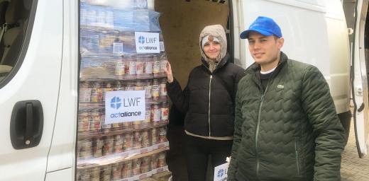 LWF humanitarian support officer Katerina Brzicova and Samuel Reslour, a volunteer, assist in transporting relief items to a warehouse of the Polish Humanitarian Action (PAH), which is partnering with the LWF to distribute food and non-food items to refugees fleeing from Ukraine at the Zosin and Dohoruth borders. Photo: B. Khanal