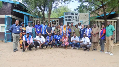 Rev. Dr Anne Burghardt with LWF World Service staff in front of the LWF office in Kakuma