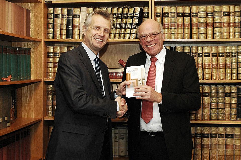 LWF General Secretary Rev. Martin Junge (l) receives a copy of the VELKD publication 