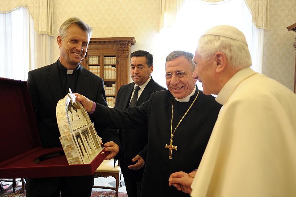 December 2010: LWF General Secretary Rev. Martin Junge (left) and LWF President Bishop Dr Munib A. Younan (middle) present Pope Benedict XVI with a gift from Bethlehem depicting the Last Supper. Â© Servizio Fotografico 
