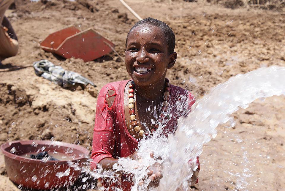 A splash of fresh water from a newly constructed borehole at Teferi Ber refugee camp, Ethiopia. Â© LWF/R. Bueno De Faria