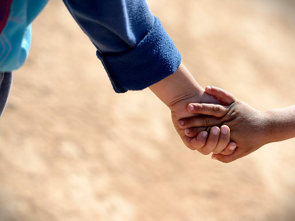 Children holding hands in the Za'atri refugee camp. The LWF is present in Jordan supporting Syrian refugees with winter clothing, winterization of tents, prefabricated container houses and psychosocial support. Â© Magnus Aronson