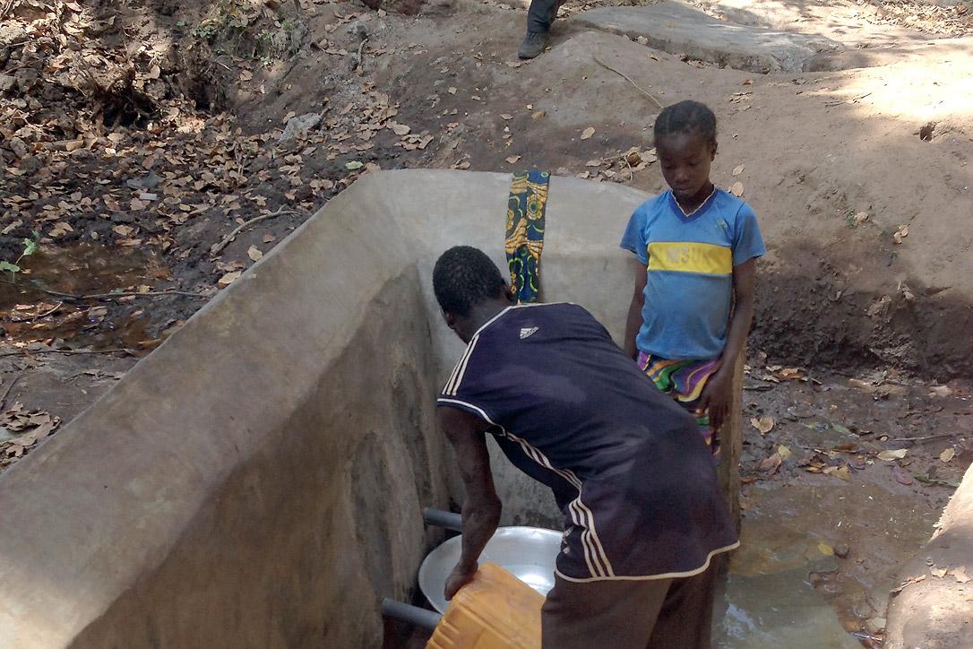Drawing water from a source that was recently rehabilitated by the LWF in Nana MambÃ©rÃ©, Central African Republic. Photo: LWF/CAR