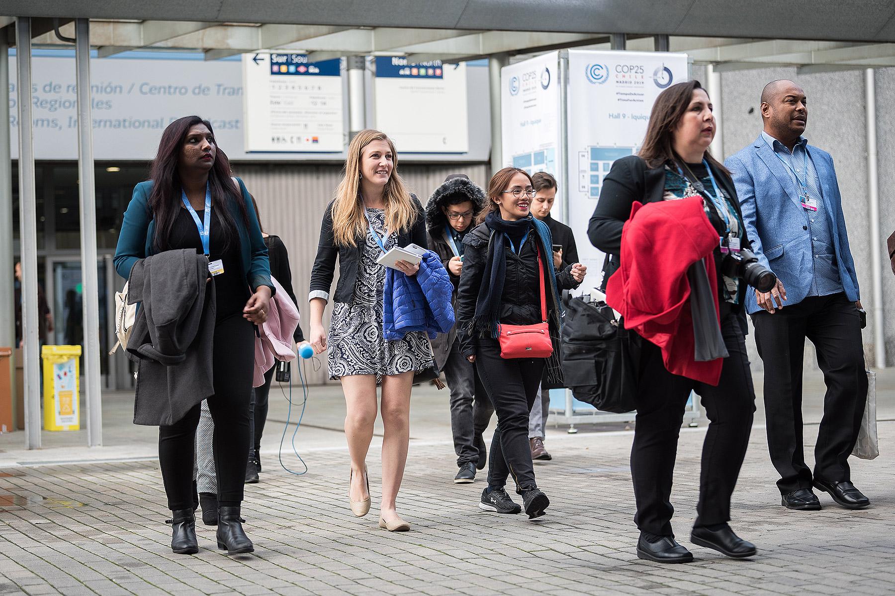  LWF Secretary for Youth Ms Pranita Biswasi (left) and other members of the LWF delegation walk toward the plenary hall on day one of COP 25 in Madrid.  LWF/Albin Hillert    