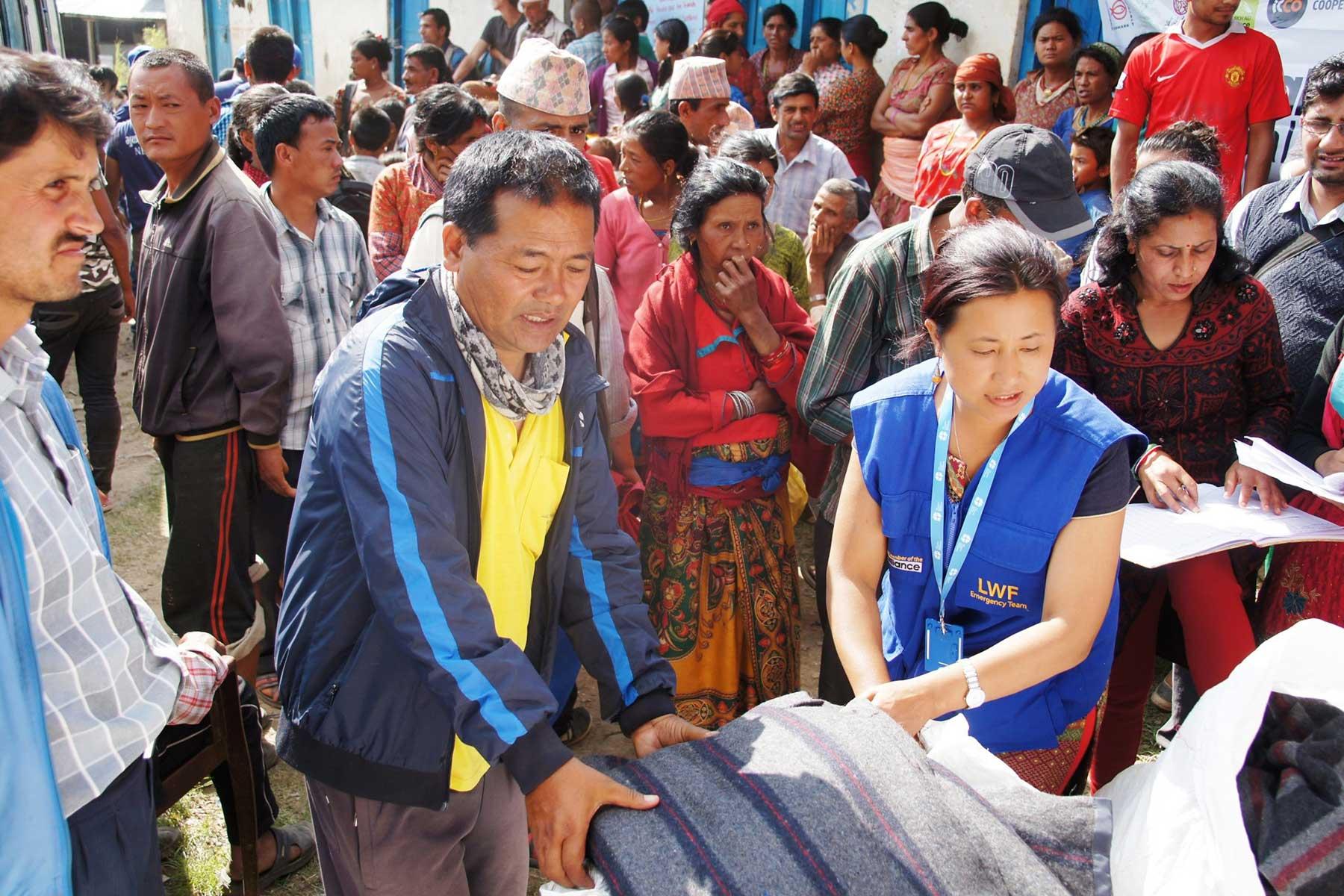 LWF Nepal staff distribute blankets and other items for emergency shelter in Nepal after the earthquake in 2015. Although many of them were affected themselves, all colleagues reported for duty and went out to support those who had lost even more. Photo: LWF/ C. KÃ¤stner 