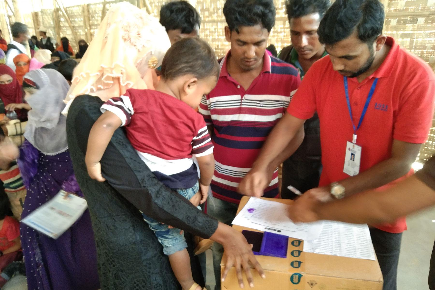 Rohingya refugees in Coxâs Bazaar IDP camp receive a distribution of WASH kits by LWF's local partner. Photo: LWF/ B. Khanal