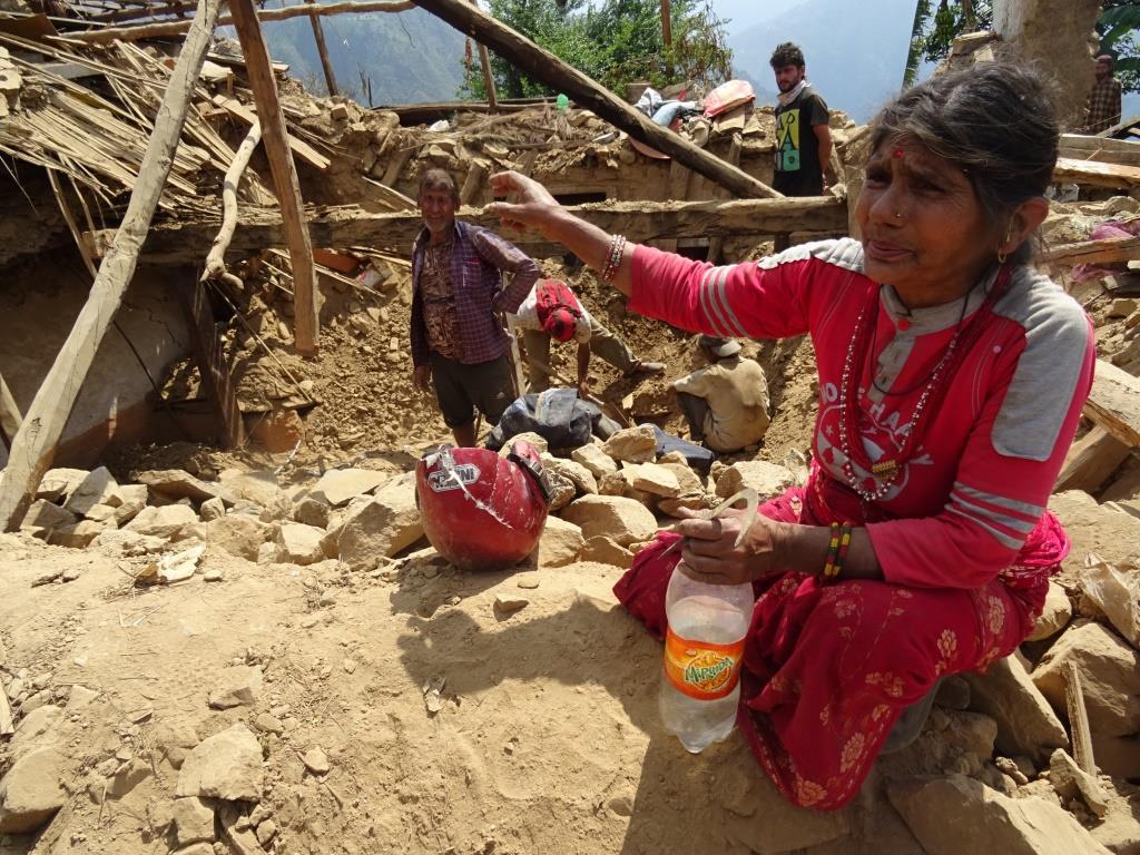 After the earthquake in Nepal, local villager searches for cooking utensils in the debris.  Photo:  LWF/C.Kaestner