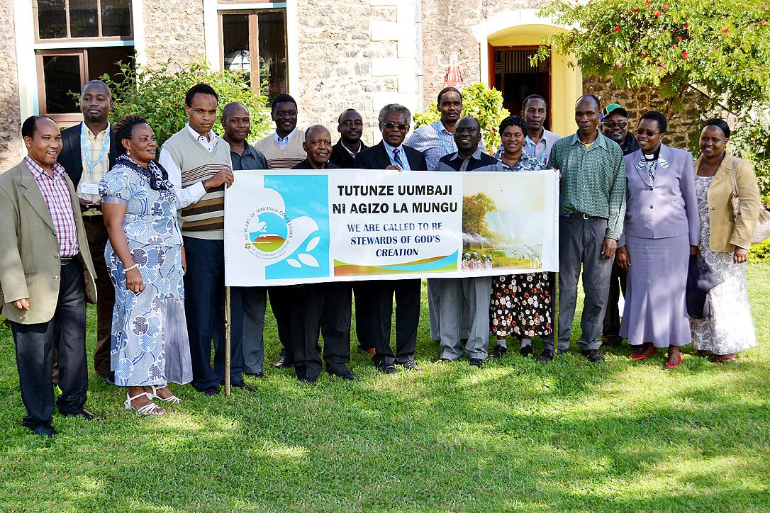 Members of the Marangu Conference pose for a group photo after the blessing for the two climbers with the LWF banner. Photo: David Adgea/ELCC