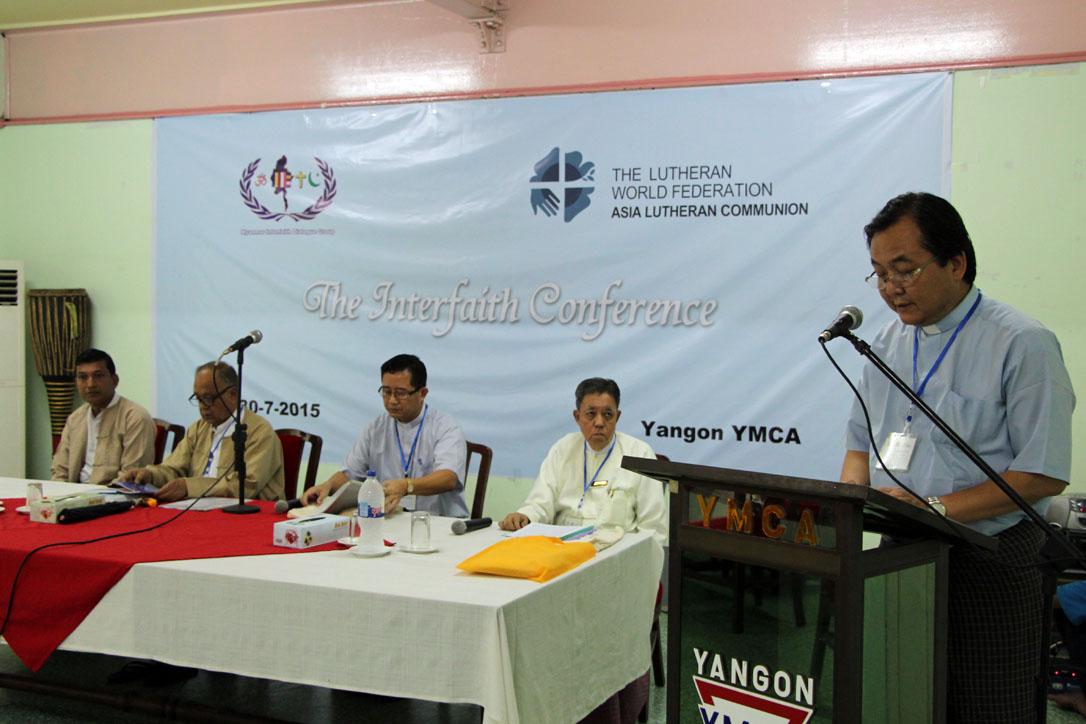 Rev. Saw Shwe Lin, General Secretary of Myanmar Council of Churches greeting the participants, witnessed by faith leaders from Myanmar. Photo: LWF/S. Lawrence
