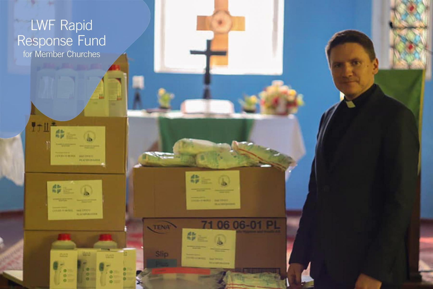 The Lutheran Church in Grodno, Belarus, Rev. Vladimir Tatarnikov stands with supplies purchased with LWF COVID-19 Rapid Response Funds. Photo: The Lutheran Church in Grodno