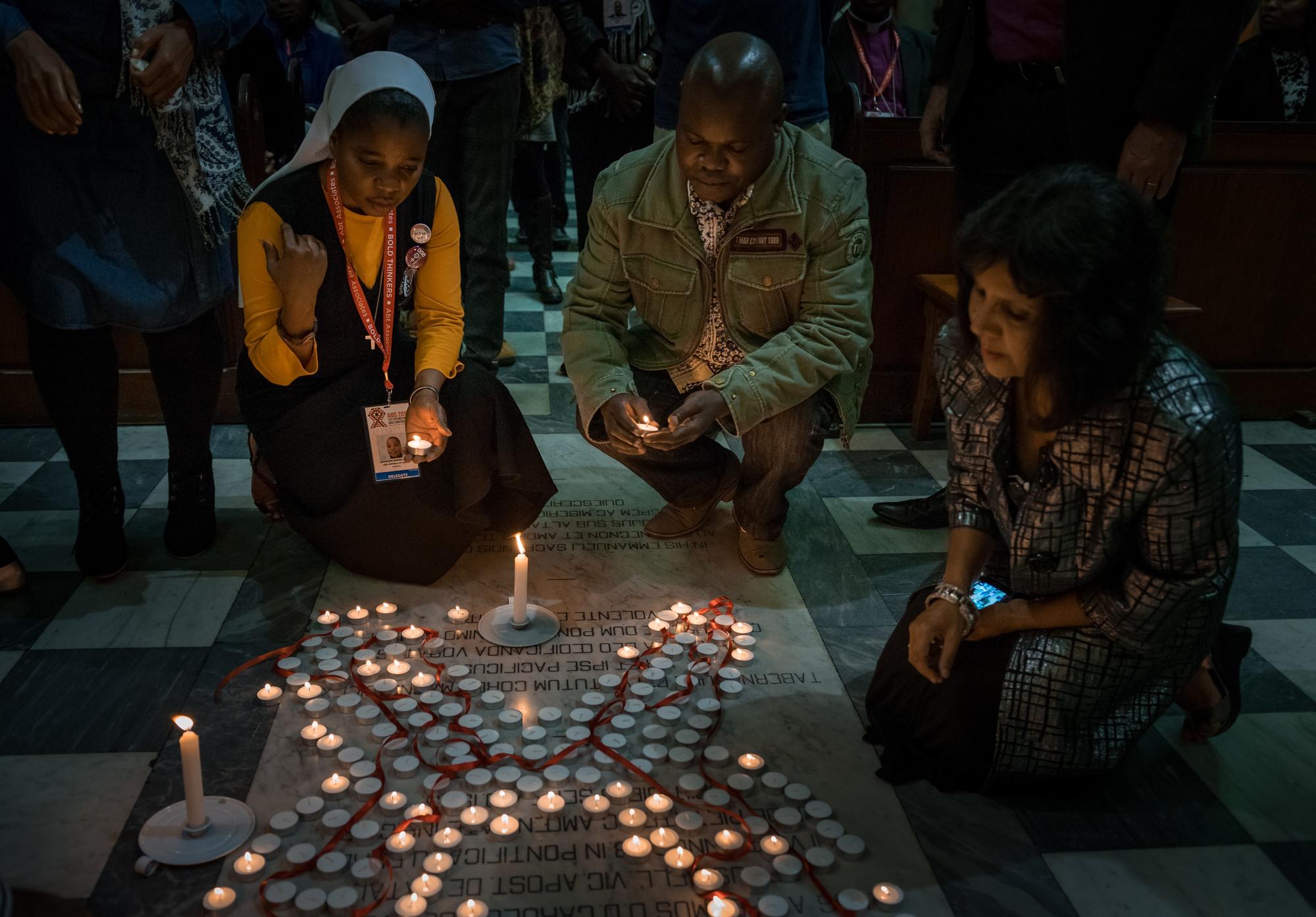 Participants light candles during a July 19 interfaith prayer service, held at the Roman Catholic Emmanuel Cathedral in Durban, South Africa, during the 2016 International AIDS Conference