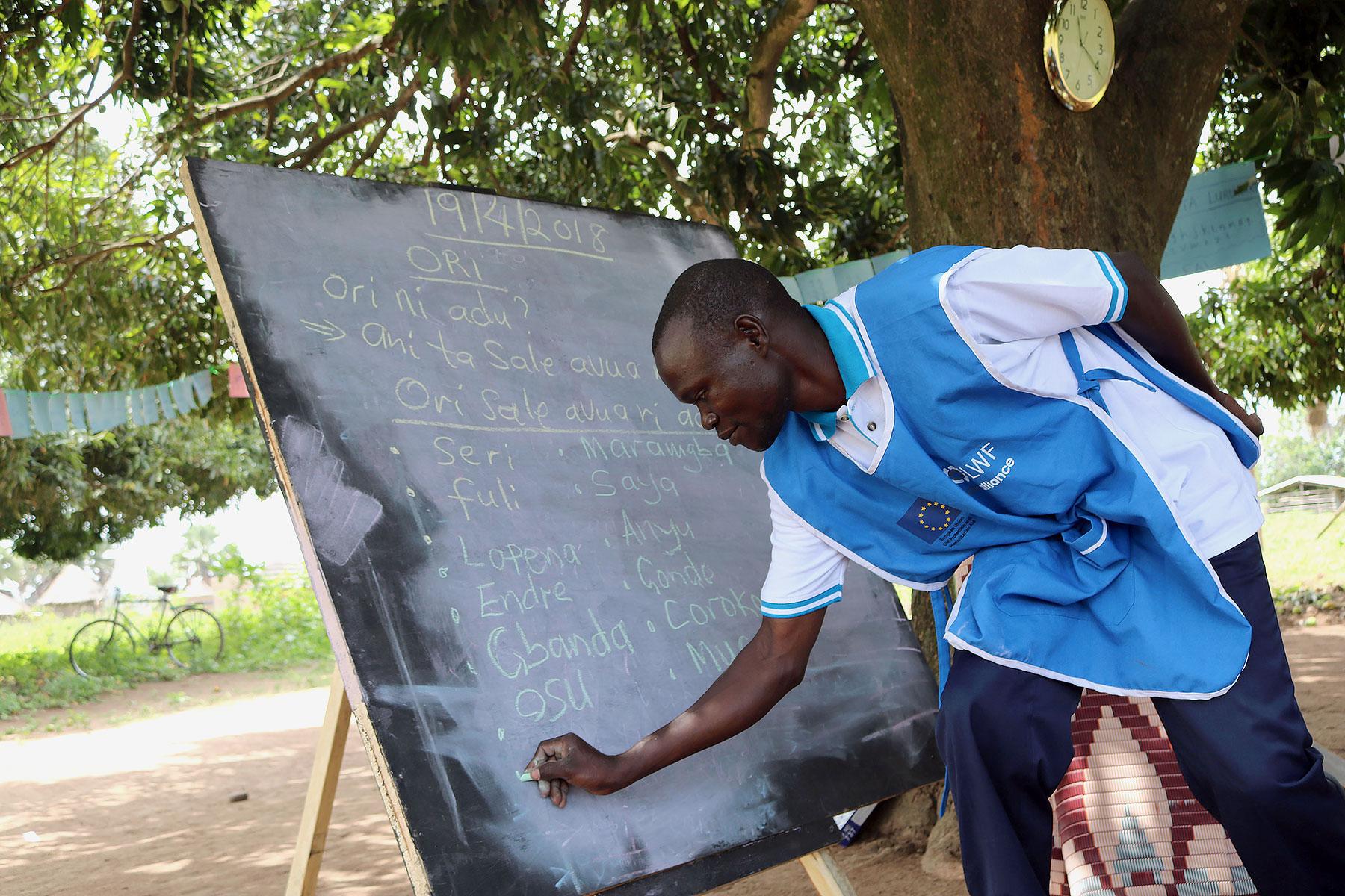 Paul Sunday Odriga teaches students at at Duba Functional Adult Learning Centre in Adjumani district. Photos: LCCN