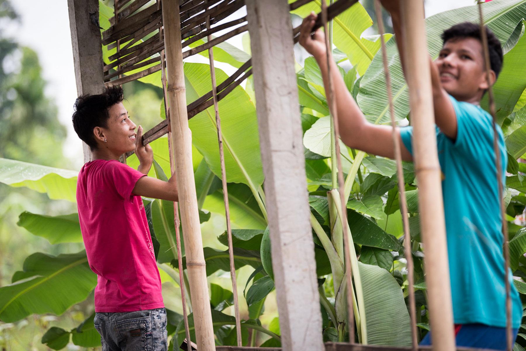Two young men construct a house in the Beldangi Refugee Camp in southeast Nepal. Photo: LWF/Albin Hillert