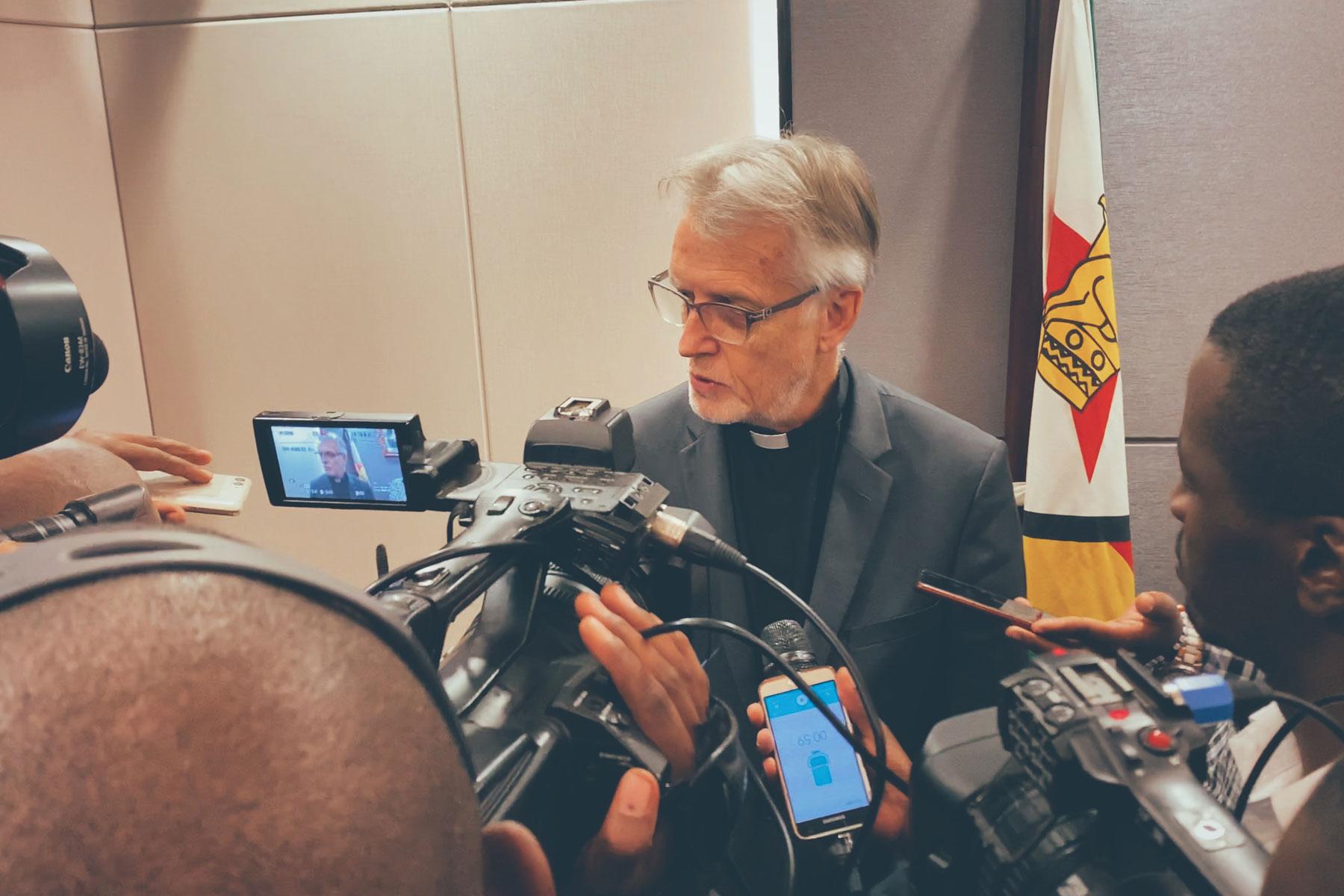 Journalists interview LWF General Secretary Martin Junge following a meeting with government officials in Harare. Photo: LWF/A. Danielsson