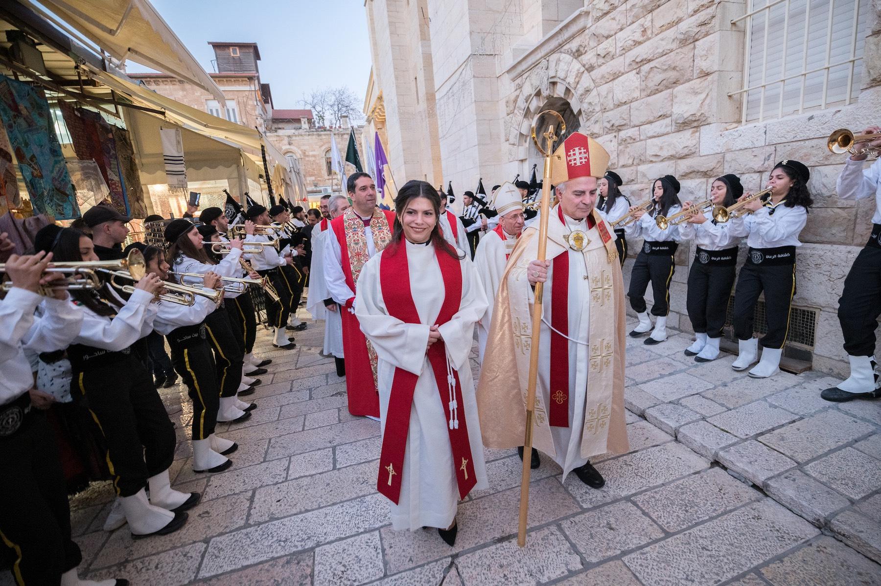 22 January 2023, Jerusalem, Palestine: Rev. Sally Azar, ordained minutes earlier as pastor in the Evangelical Lutheran Church in Jordan and the Holy Land, exits the church in procession together with her Bishop Sani Ibrahim "Barhoum" Azar. Photo: LWF/ Albin