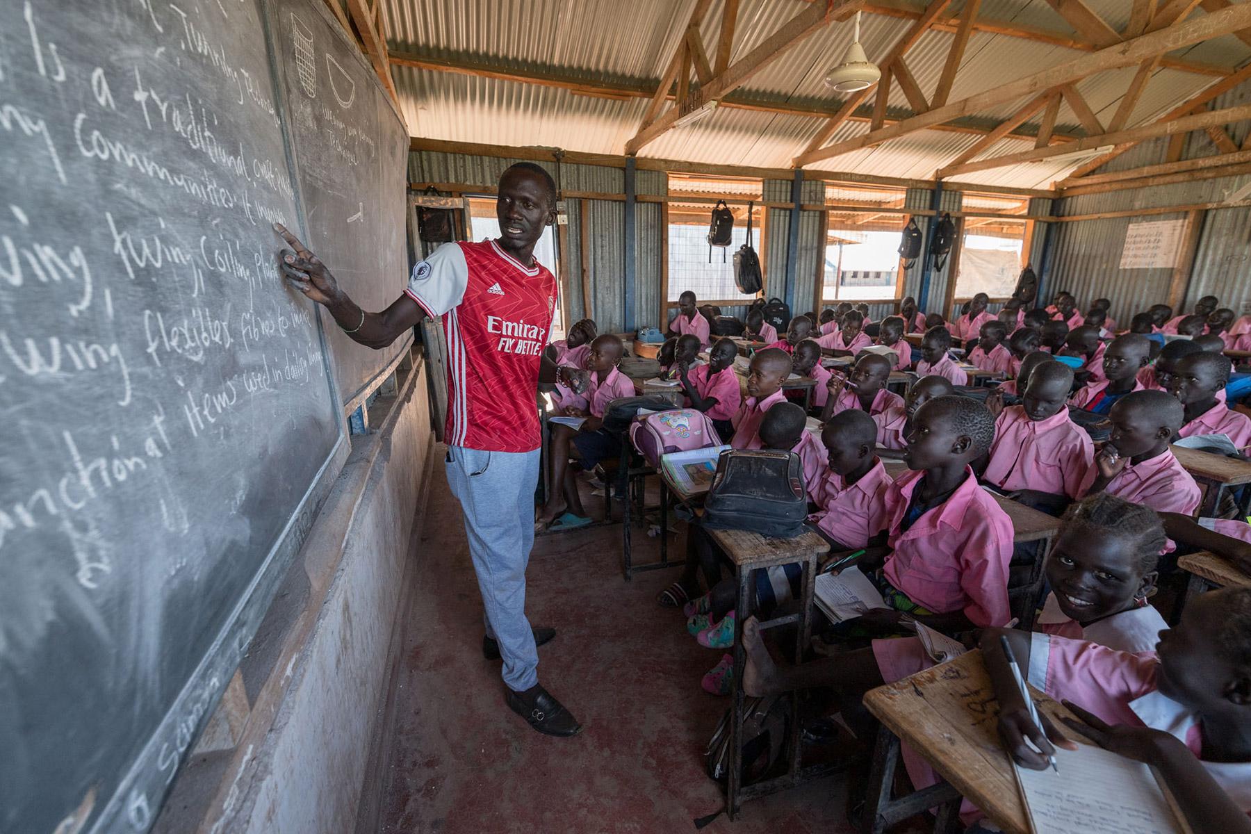 Teacher James Lobalu, teaches a class of fourth-graders at Peace Primary School. Photo: LWF/ Albin Hillert
