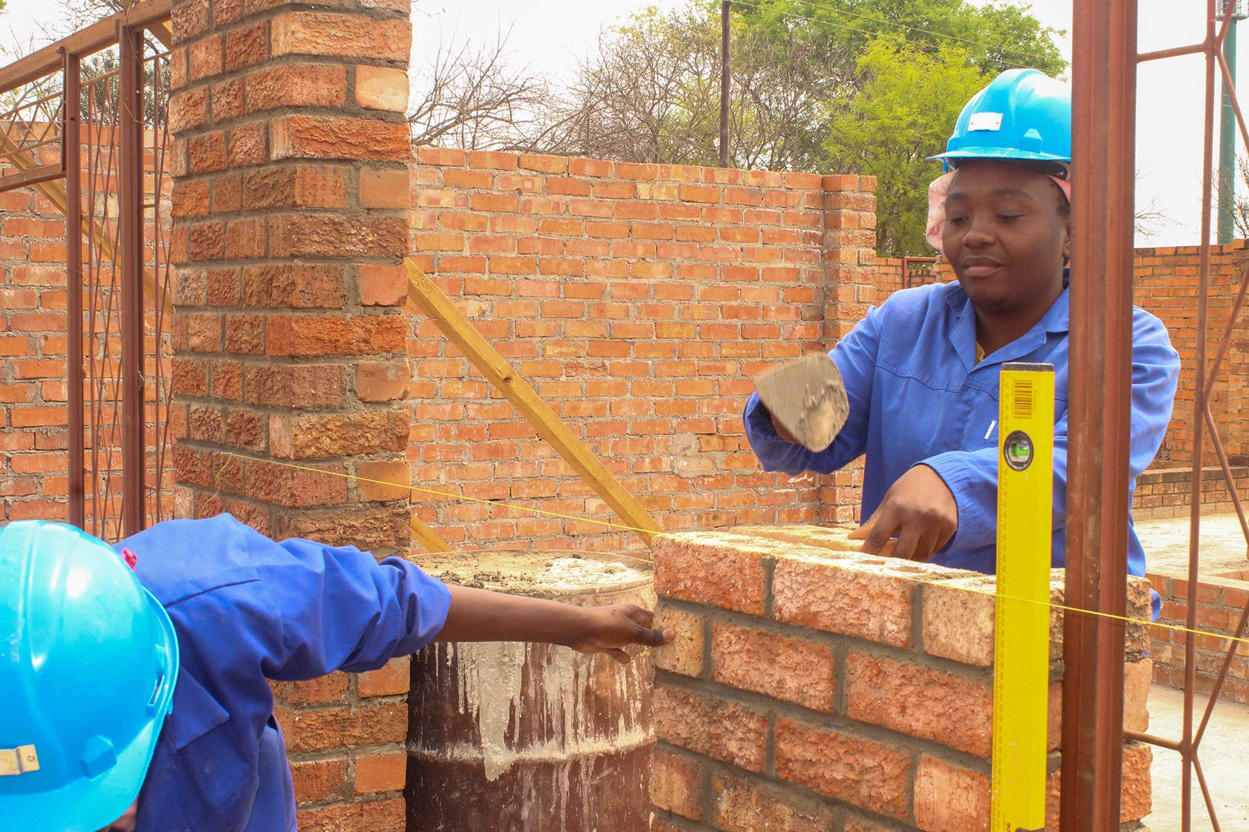 Nomathemba Sibanda displays her masonry skills at the public works site in Filabusi town, southern Zimbabwe. Photo: LWF/Monmo Dahiru Moodi