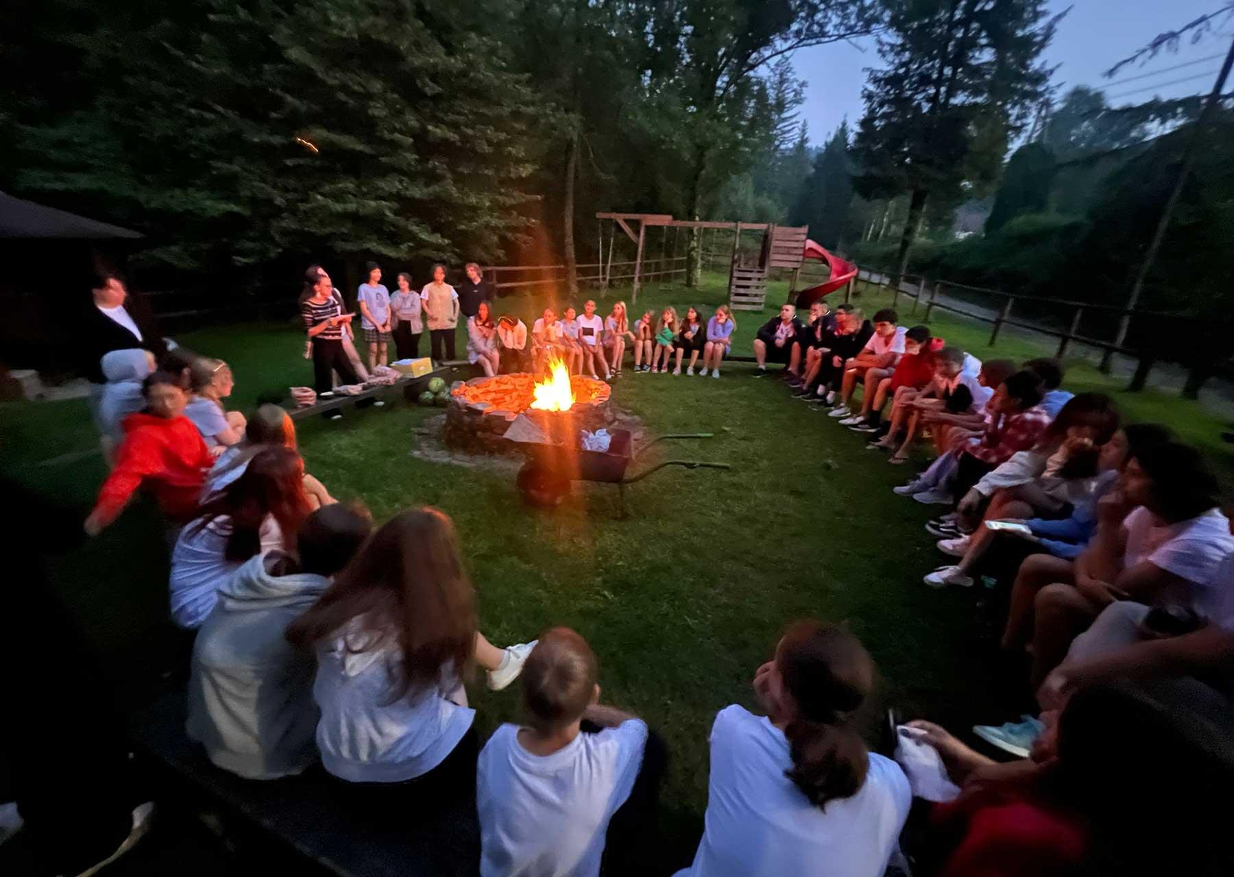 Teenagers around a campfire in the Wisla mountains. Older children in particular benefitted from the opportunity to spend time away from home and with peers . Photo: LWF Poland