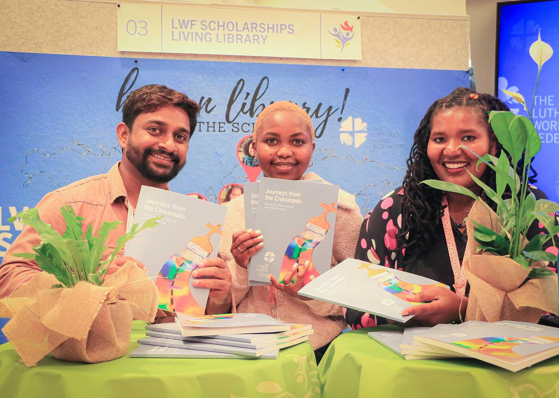 Three LWF scholarship holders at the Thirteenth Assembly in Krakow with copies of the recent publication ‘Journeys from the Crossroads’ which showcases stories on “living, studying and doing theology.” Photo: LWF/J.C. Valeriano