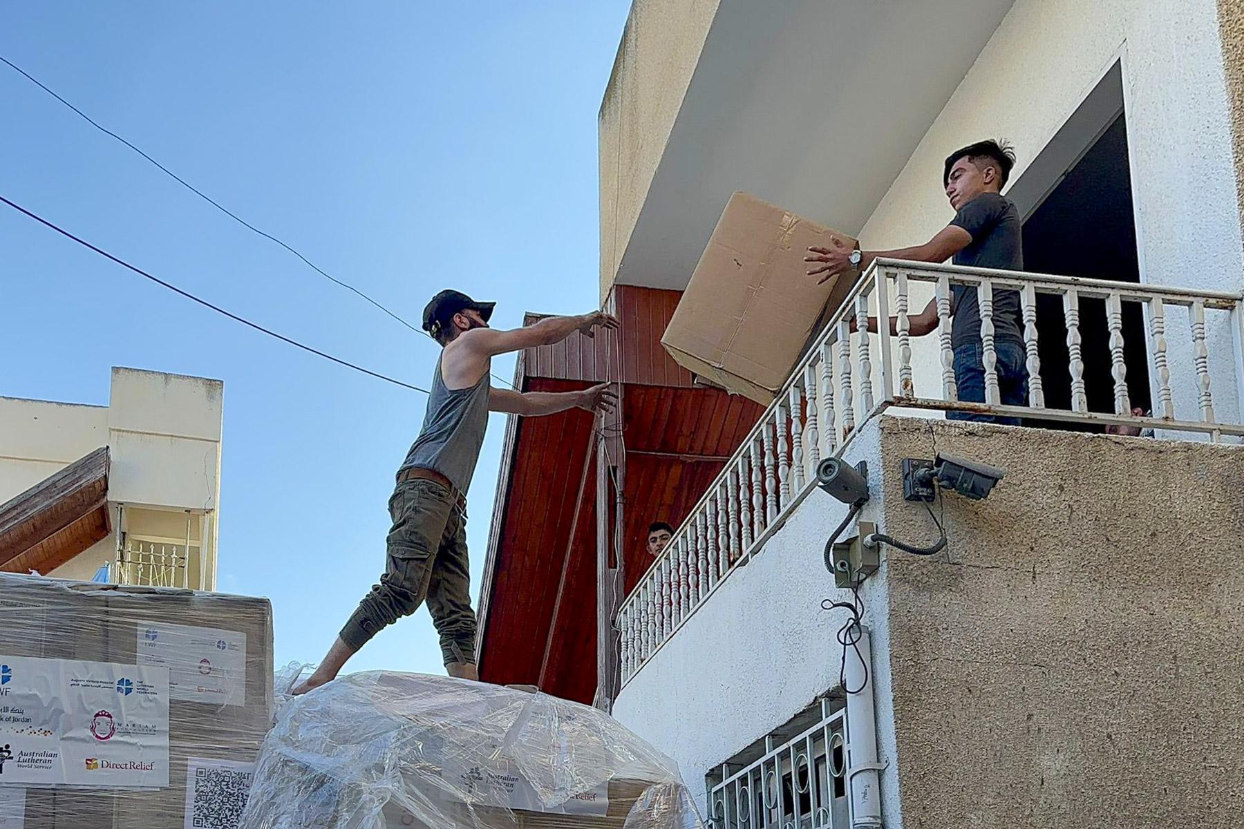 Personnel at the Ahli Arab Hospital off-loading the LWF medical supplies from a delivery truck. Photo: LWF Jordan