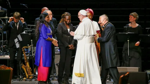 Pope Francis talks to Pranita Biswasi and Rose Lokonyen, foreground, two presenters who offered testimonies at Together in Hope. Bishop Dr Munib Younan, LWF President, stands to the right. Photo: Mikael Ringlander/Ikon