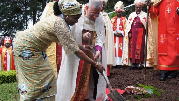 LWF Council member Ms Titi Malik and LWF President Bishop Munib A. Younan plant a commemorative tree for the 60th anniversary of the first Lutheran conference in Marangu. Photo: LWF/Tsion Alemayehu