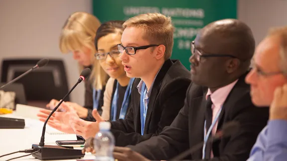 Piotrek Sztwiertnia, member of the LWF delegation speaks to an interfaith meeting during the COP19 climate change conference in Warsaw. Photo: LWF/Sean Hawkey