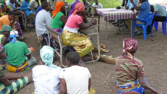 LWF staff collect information about human rights concerns at a village in Mozambique. Photo: S. Oftadeh