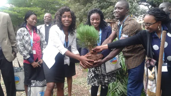 Global Young Reformers Network members plant a tree during an exposure visit to Majengo Parish in Moshi, Tanzania. From left: Sam Ofonime (Nigeria), Rev. Helvi Muremi (Namibia), Anderson Cooper (Liberia) and Sikhanyiso Mhaka (Zimbabwe). Photo LWF/Allison Westerhoff 