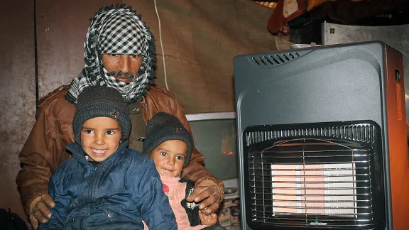 Mohammad and his two daughters in their tent. Photo: LWF/Julia Tarpy