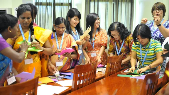 Women delegates from LWF member churches in Asia make paper windmills at the Women in Church and Society meeting, held before the regional Pre-Assembly. Photo: LWF/A. Danielsson