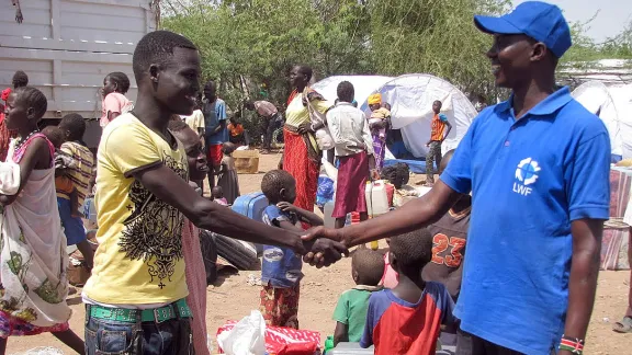 LWF staff member John Ekamais, right, with one of the new arrivals at the Kakuma reception center. Photo: LWF/James Macharia