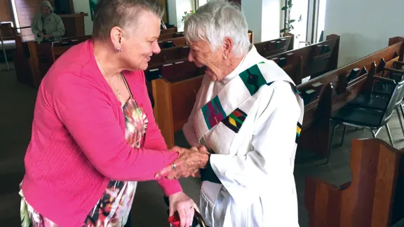 A minister greets a parishioner at the church at Faith, Province of British Columbia. Photo: Canada Lutheran