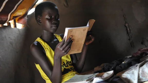 A young girl, refugee from South Sudan, studies in Adjumani, Northern Uganda. Lack of sanitation threatens the improving school enrolment for girls. Photo: LWF/ M. Renaux