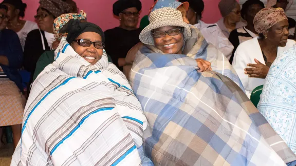 Quilts are handed out to the Busiswe Luncheon Club, South Africa. The club is a group of elderly who meet daily to sing, share meals, and support each other while their families are working and in school. All photos: CLWR