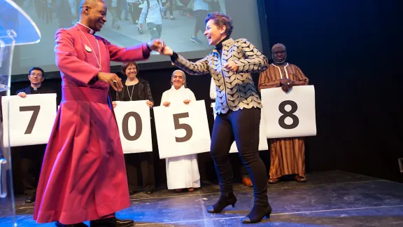 Christiana Figueres, Executive Secretary of the United Nations Framework Convention on Climate Change, dances with Archbishop Thabo Makgoba of South Africa to celebrate some 1.8 million signatures on an interfaith petition for climate justice during the COP21 climate summit in Paris, France. Photo: LWF/R. Rodrick Beiler