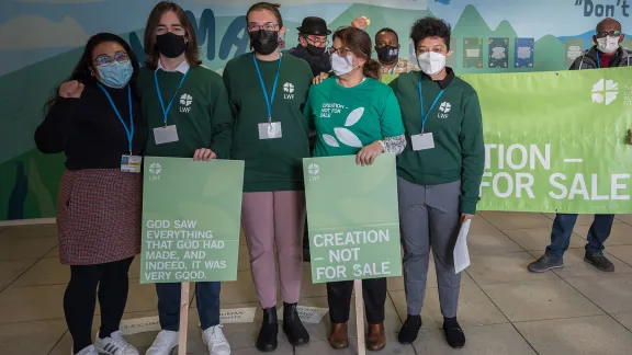 Delegates from the Lutheran World Federation and ACT Alliance standing together for the message of âCreation - Not for Saleâ during COP26 in Glasgow. Photo: LWF/Albin Hillert