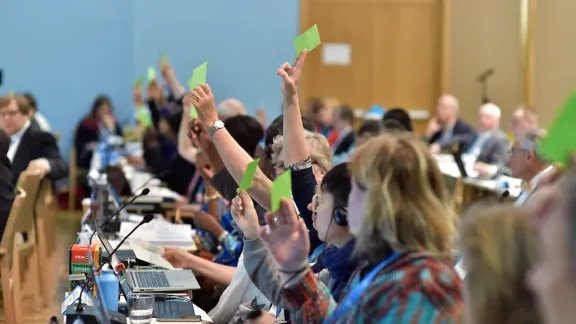 Holding the green card: members of the LWF Council vote on a proposal at the 2016 Council meeting. Photo: LWF/M. Renaux