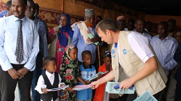 LWF Country representative Lennart Hernander hands out the school books from the new curriculum to first year students. Photo: LWF Kenya-Djibouti