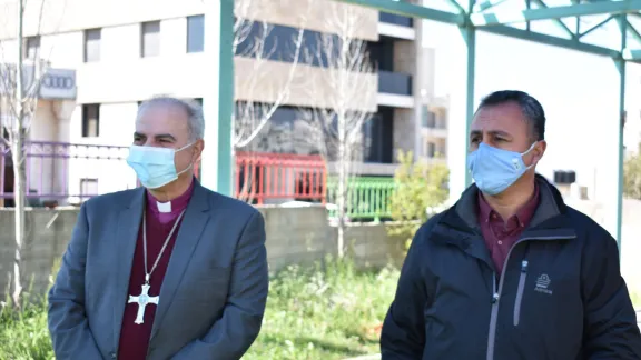 Bishop Azar and EEC Executive Director Simon Awad plant trees in the 