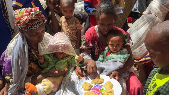 People taste the pancakes made in a cooking distribution with the enriched âFamixâ flour, distributed to displaced people in Tigray. All photos: LWF/ S. Gebreyes 