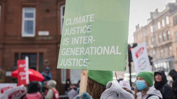 During the UN climate conference COP26, LWF delegates joined a climate march. One banner read âClimate justice is intergenerational justiceâ. Photo: LWF/Albin Hillert