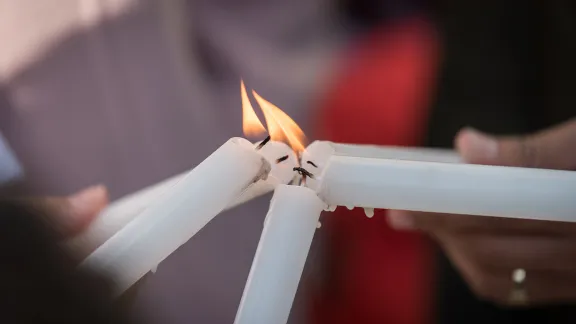 Lighting candles during a prayer at COP25 in Madrid, Spain. Photo: LWF/Albin Hillert