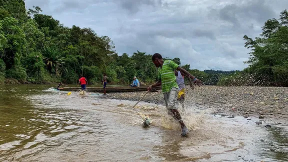 Youth playing on the banks of RÃ­o Pogue in Atrato, northwestern Colombia. The LWF supports local communities to uphold their rights and protect the Atrato River, which has been polluted by material from extractive industries for decades. Photo: LWF/G. A. Moreno Clavijo