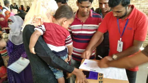 Rohingya refugees in Coxâs Bazaar IDP camp receive a distribution of WASH kits by LWF's local partner. Photo: LWF/ B. Khanal