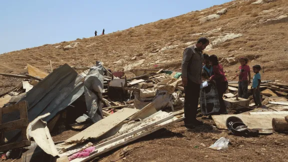 People pick through rubble at the site of a demolition in Wadi Sneysel, in the West Bank near East Jerusalem.