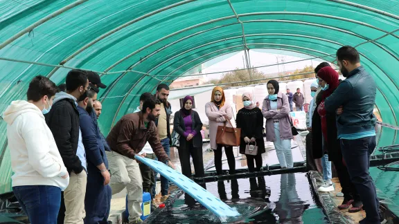 LWF Jordan staff, refugees and host community members take part in a training on hydroponics farming. The system uses 90 percent less water compared to conventional farming, and it is powered by photovoltaic panels, which also reduce fossil fuel energy consumption. Photo: LWF Jordan/Daham Al-Hamad