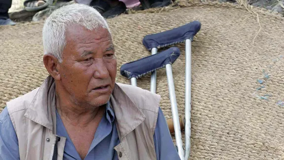 KC sitting in front of his destroyed house. Photo: Kosh Raj Koirala